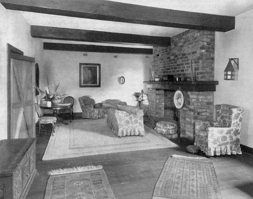Original caption: "In the living room, with its big ceiling beams and wide floorboards, friends seem to think the experiment has quite justified itself."
